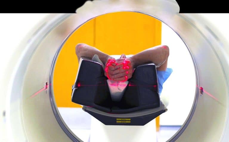 Radiographer operating a PET‑CT scanner, illustrating core imaging principles and practical skills taught in PET‑CT essentials training.